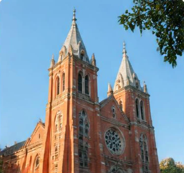 Red brick spires against a blue sky